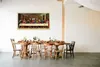 A dining table set for a meal, with a large framed painting of 'The Last Supper' hanging on the wall above it. Náhľad obrázku produktu