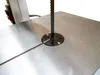A close-up view of a band saw blade and table. Anteprima dell’immagine prodotto
