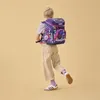 A child wearing a backpack, walking. Produktbild-Vorschau