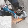 A person is using a Bosch angle grinder to cut a metal rebar embedded in concrete. Produktbild-Vorschau