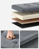 Collage showing the layered construction of a storage bench, a close-up of a hand pressing into the seat to demonstrate cushioning, and a close-up of the fabric texture. Produktbild-Vorschau