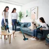 Three women and a dog in a living room, two women are using vacuum cleaners. Náhled obrázku produktu