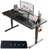 A black standing desk with a computer monitor, keyboard, laptop, and headphones. Produktbild-Vorschau