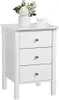 A white three-drawer nightstand with a vase of flowers and a teacup on top. Produktbild-Vorschau