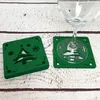 A stack of green Christmas tree coasters with a wine glass on one of them, placed on a wooden surface. Produktbild-Vorschau