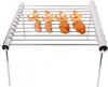 A portable stainless steel grill rack with food items on it. Produktbild-Vorschau