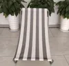 A striped beach chair is shown in a room with plants in the background. Produktbild-Vorschau
