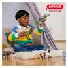 A young boy is playing with toy dinosaurs inside a tent. Náhľad obrázku produktu