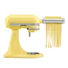 A yellow KitchenAid stand mixer with a pasta attachment is shown, producing strands of pasta. Produktbild-Vorschau