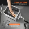 A hand is cleaning a stainless steel meat mixer with a sponge. The mixer is on a countertop, and there are some accessories nearby. Náhľad obrázku produktu
