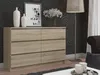 A dresser with six drawers is shown in a room with patterned wallpaper and a floor lamp. Podgląd zdjęcia produktu