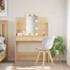 A bedroom scene featuring a vanity table with a lighted mirror, a chair, and a bed. Podgląd zdjęcia produktu