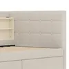Close-up view of a beige upholstered bed frame with a tufted headboard and built-in shelving. Produktbild-Vorschau