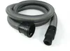 A grey corrugated hose with black connectors on both ends, coiled on a white background. Voir les images du produit