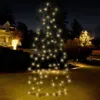 A lighted Christmas tree decoration in a yard at night, with a house and other decorations in the background. Podgląd zdjęcia produktu