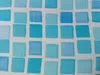 A close-up view of a mosaic pattern with blue and cyan squares on a white grid. Produktbild-Vorschau