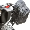 Close-up view of a black adventure pack attached to a motorcycle's rear rack. Produktbild-Vorschau