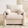 A single beige armchair is shown in a well-lit room, placed on a patterned rug. Produktbild-Vorschau