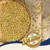 A wooden bowl filled with barley grains on a wooden surface, with scattered grains and a marketing badge. Produktbild-Vorschau