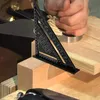 A close-up shot of a woodworking tool measuring a piece of wood. Produktbild-Vorschau