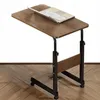 A mobile, height-adjustable bedside table with a laptop on it, shown on a wooden floor. Podgląd zdjęcia produktu