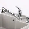 A close-up view of a chrome faucet and soap dispenser mounted on a gray sink. Produktbild-Vorschau
