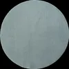 A circular rug on a black background.