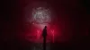 A person stands in a dark, red-lit environment facing a swirling vortex-like structure. Podgląd zdjęcia produktu