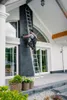 A person is using a ladder to reach a high part of a building exterior. Produktbild-Vorschau