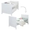 A white baby crib is shown in the top half of the image, and the same crib converted into a toddler bed is shown in the bottom half. A curved arrow indicates the transformation. Produktbild-Vorschau