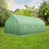 A green tent-like structure, likely a greenhouse or storage tent, is set up on a grassy lawn surrounded by trees and a bright sky. Náhled obrázku produktu