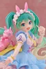 A close-up of a Hatsune Miku figurine dressed in a fairy tale-themed outfit, complete with bunny ears and a blue dress, standing next to a pink toy horse. Produktbild-Vorschau