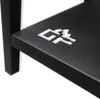 A close-up of a black metal shelf with a silver logo. Produktbild-Vorschau