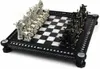 A Harry Potter themed chess set with silver and black pieces on a black and white checkered board. Podgląd zdjęcia produktu