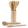 A set of bamboo kitchen utensils in a holder, with a pair of tongs and a slotted spoon in the foreground. Podgląd zdjęcia produktu