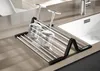 A dish drying rack with two wine glasses placed on it, next to a kitchen sink. Produktbild-Vorschau