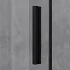 A close-up view of a black shower door handle against a textured gray background. Produktbild-Vorschau