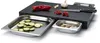 A cutting board with integrated drawers, containing chopped vegetables and mushrooms. A knife, garlic, and red pepper are on the cutting board. Voir les images du produit