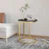 A side table with books and a plant on it, next to a sofa. Náhľad obrázku produktu