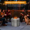 People and a dog gathered around a fire pit on a wooden deck at dusk. Produktbild-Vorschau