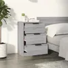 A bedside table with three drawers next to a bed. Produktbild-Vorschau