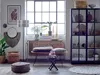A cozy living room scene with a rattan bench, decorative items, and plants. Produktbild-Vorschau