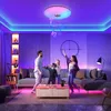 A family is dancing in a living room illuminated by colorful LED lights. Voir les images du produit