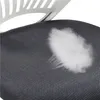 A close-up view of a dark gray mesh fabric, possibly from a chair, with a white cloud-like pattern or effect on it. Part of a white chair back is visible in the upper left corner. Produktbild-Vorschau