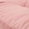 A close-up view of a pink textured fabric, likely a cushion or upholstery. Produktbild-Vorschau