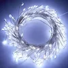 A coiled string of white LED lights with a copper wire. Produktbild-Vorschau