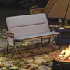 A camping scene at night with a two-person bench, tent, and campfire. Produktbild-Vorschau
