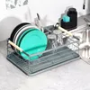 A dish rack filled with dishes and glasses is placed next to a sink. Produktbild-Vorschau