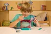 A young boy is setting up an Aqua Dragons habitat in a room. Voir les images du produit