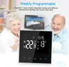 An elderly couple is smiling in the background behind a digital thermostat display. Podgląd zdjęcia produktu